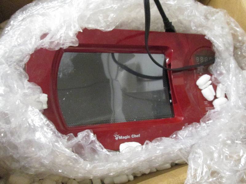 Red Microwave by Magic Chef open bo...