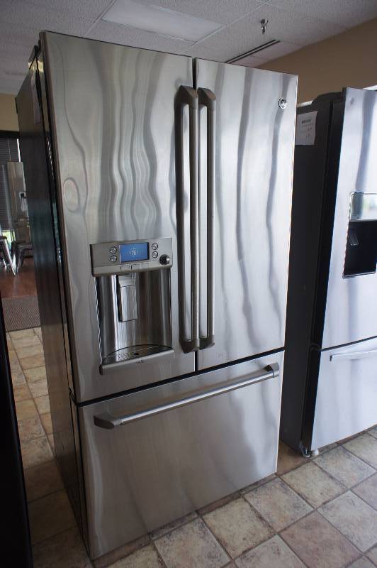 lot 16 image: PREVIOUSLY OWNED - Scratch and Dent - GE Cafe Series -  Model # (CYE23TSDSS) - 23.1 cu. ft. Counter-Depth French Door Refrigerator - Stainless Steel- Tested Works - MSRP $ 1899.99