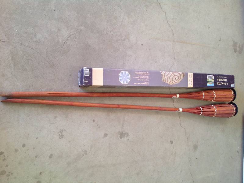 lot 74 image: Two Tiki Torches with a 6 Patio Umbrella