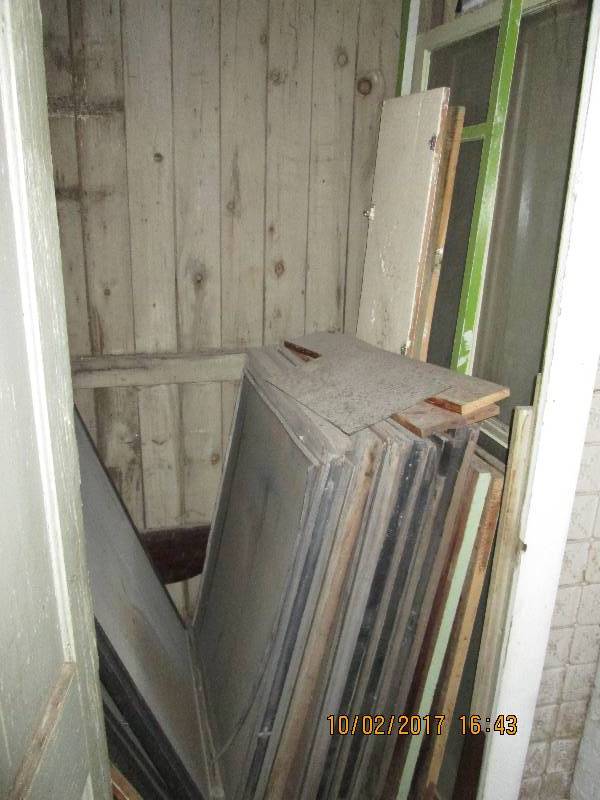 Closet filled with vintage windows,...