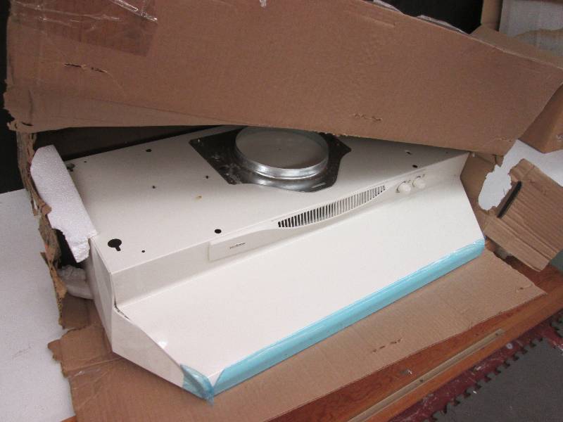 New NuTone range hood, dented corne...
