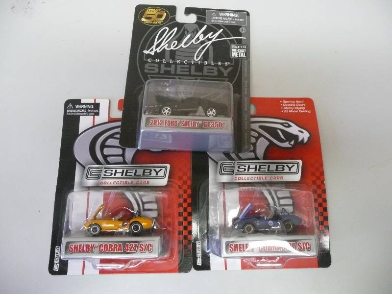 lot 9 image: 3 Shelby Collectibles - Shelby 164 - 1 2012 GT350 - 1 BLUE & 1 ORANGE COBRA 427 SC - NEW IN BOX - SEE PICTURES - VERY COOL