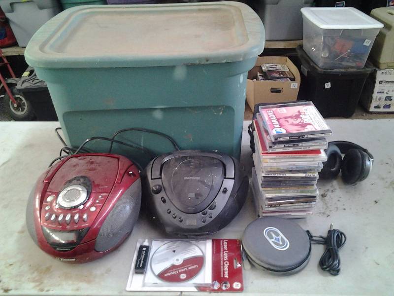 lot 24 image: Tote With Lid 2-Boom Box CD Players, Personal CD Player, Assorted CDs, Headphones