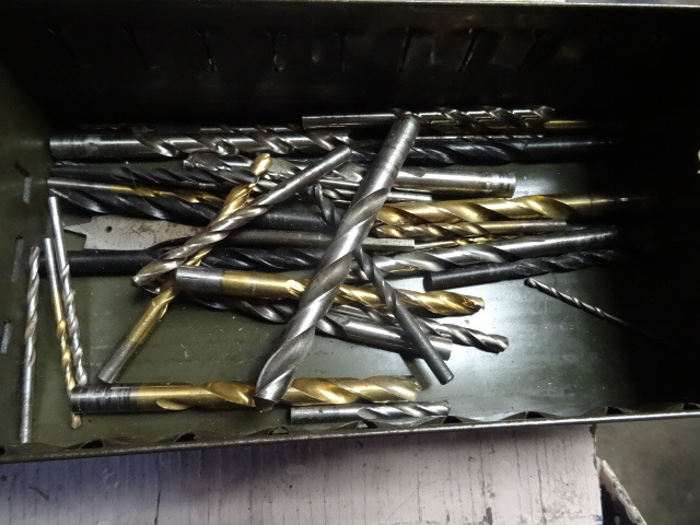 Metal bin of misc drill bits