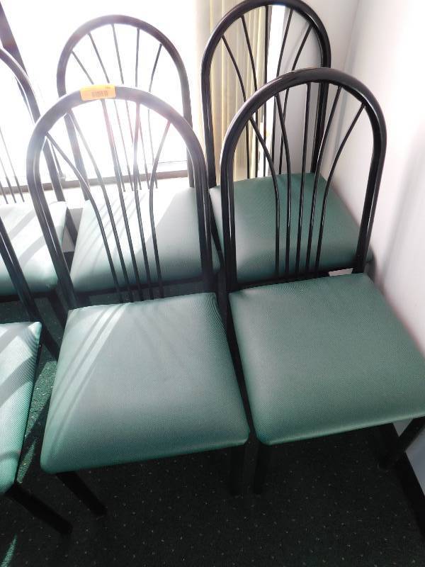 FOUR METAL FRAME CHAIRS WITH GREEN PADDED SEATS