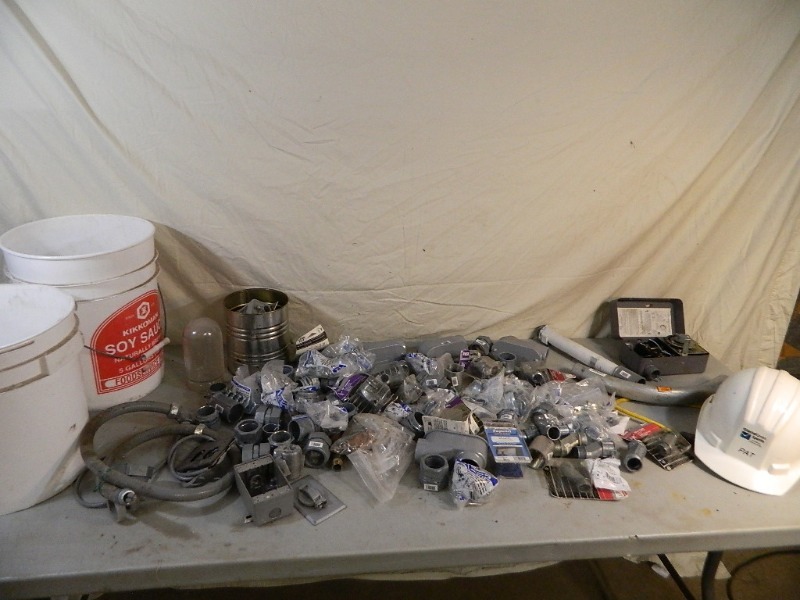 lot 106 image: Table Full of New and Used Electrical Supplies