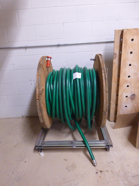 lot 114 image: Garden Hose on Metal Stand