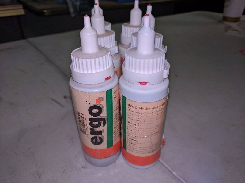 lot 184 image: (6) Ergo 4203 Hydralic Sealant Bottles