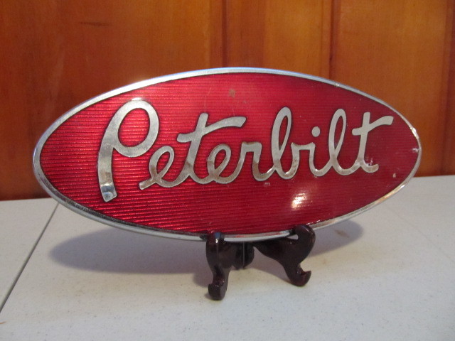 lot 53 image: Vintage PETERBILT Enamel Truck Emblem