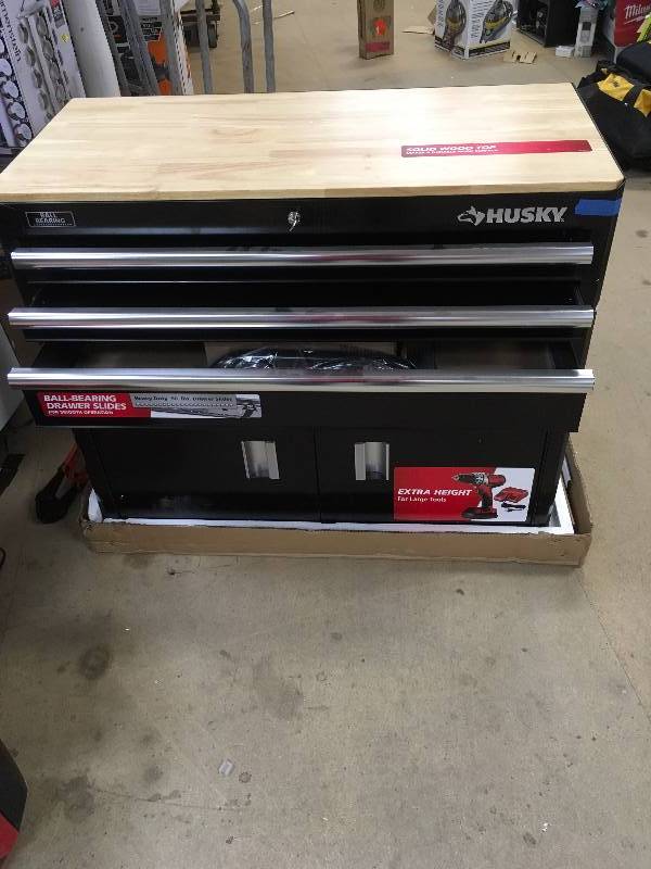 lot 123 image: Husky 39 in. 3-Drawer Mobile Workbench, Black good working condition with slight bottom side damage MSRP $239