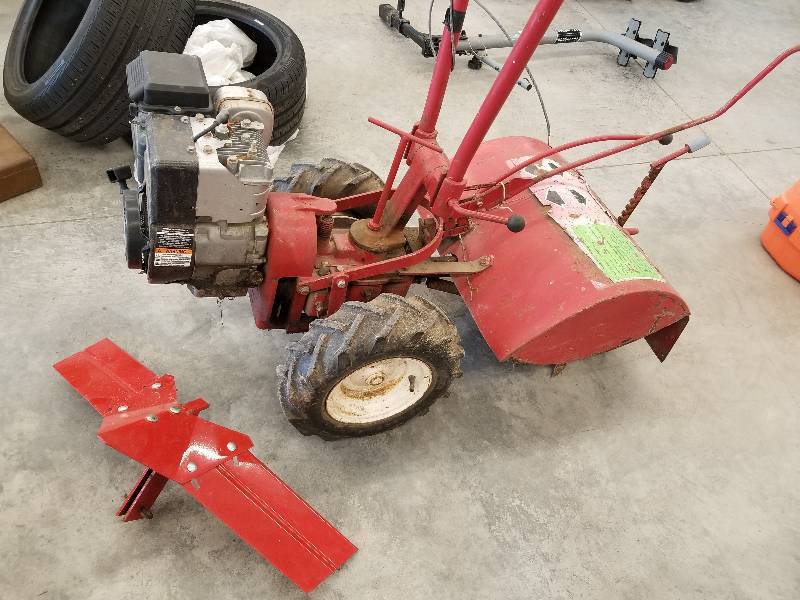 lot 70 image: Troy Bilt Rear Tine Tiller, BriggsStratton 5hp- runs.  With Misc New parts.