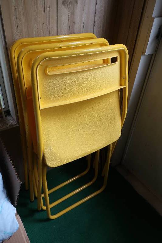 THREE YELLOW PLASTIC FOLDING CHAIRS