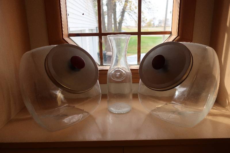 TWO GLASS COOKIE JARS AND CARAFE