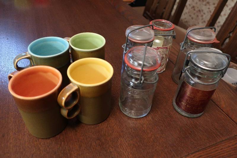 COLORED STONEWARE MUGS AND CANDY CANISTERS