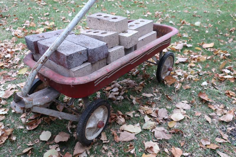 OLD RED WAGON WITH BRICKS