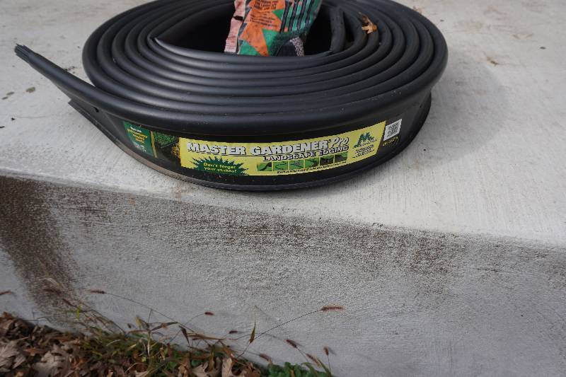 lot 56 image: 40 Roll Master Gardener Brand Landscape Lawn Edging With Bag of Sod Stakes