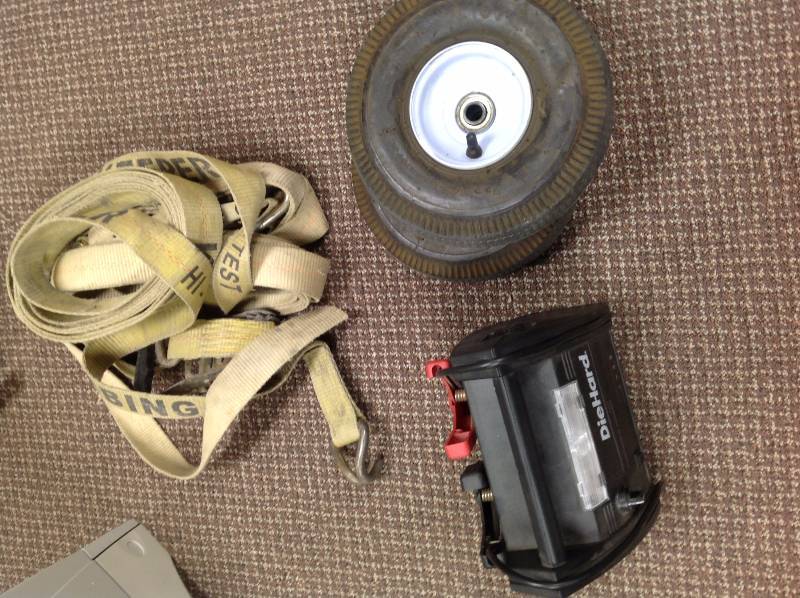 lot 26 image: Portable jumper starter, Two small Tires, Heavy Duty Tie Down