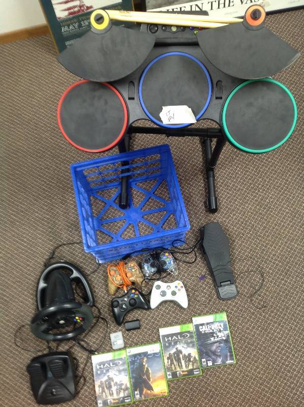 lot 61 image: Guitar Hero for the Xbox, Steering wheel, Four Controllers one Camo, And Halo and COD