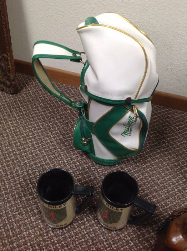 lot 64 image: 7 Vintage Bats, Case, Wine holder Golf bag, Watch, Stress balls, Two Plastic mugs, and Leather Wrapped Bottle