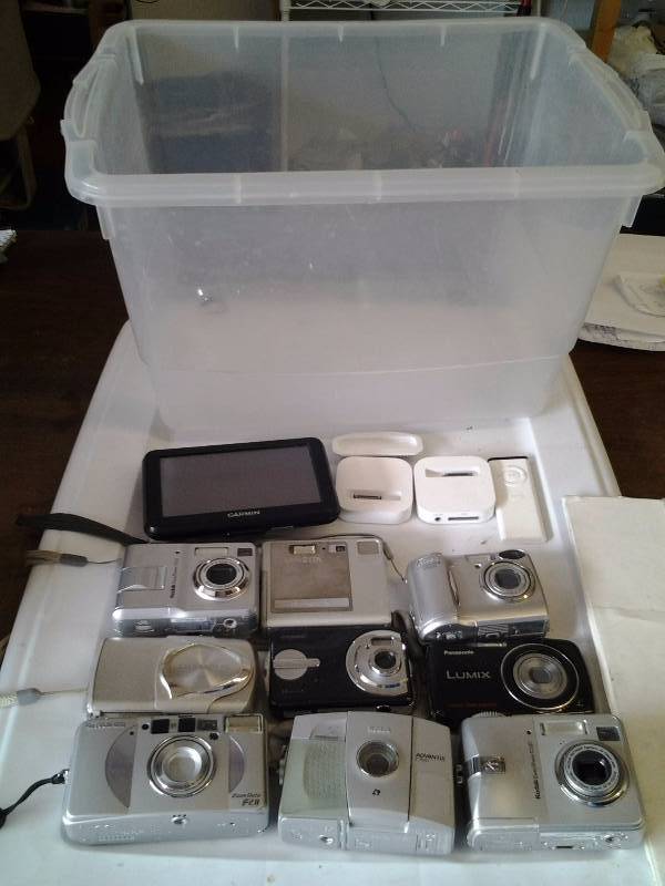 9-Digital Cameras (Kodak, Olympus, Nikon, Minolta, Others), 2-I-Pod Docks, Garmin GPS