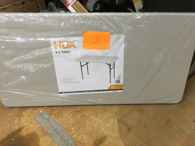 lot 21 image: HDX Earth Tan Banquet Folding Table never used wrapped in plastic
