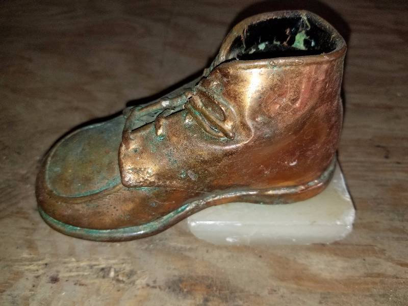 lot 12 image: Vintage copper shoe on marble