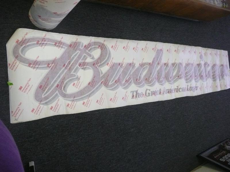 lot 36 image: RARE BUDWEISER THE GREAT AMERICAN LAGER PEEL AND STICK SIGN - CAN BE APPLIES TO ANY FINISHED SURFACE - 3M GRAPHICS PRE MASKING TAPE - APPROX 10FT LONG 2FT HIGH
