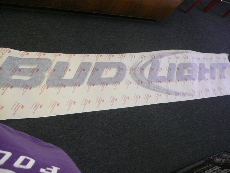 lot 37 image: RARE BUD LIGHT PEEL AND STICK SIGN - CAN BE APPLIES TO ANY FINISHED SURFACE - 3M GRAPHICS PRE MASKING TAPE - APPROX 10FT LONG 2FT HIGH