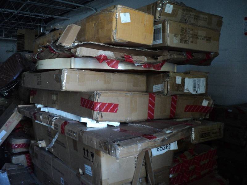 lot 103 image: pallet of overstock furniture stack...