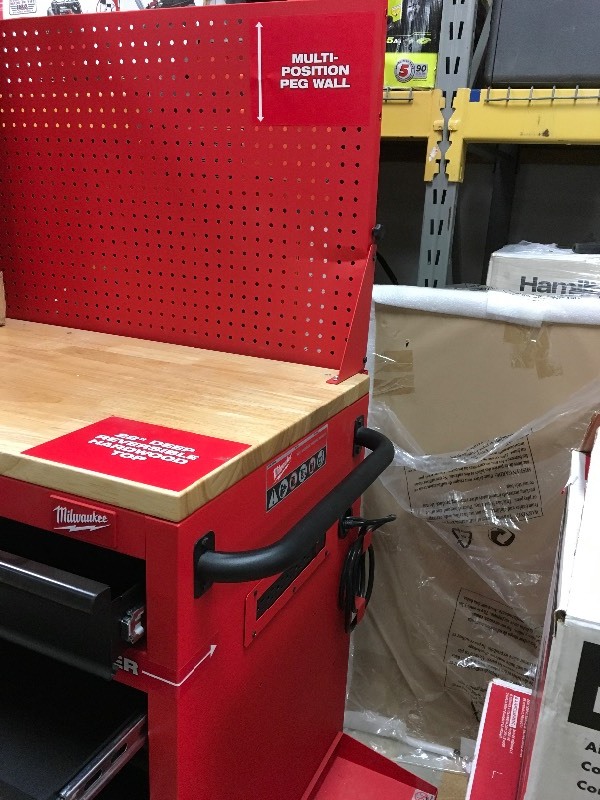 lot 31 image: Milwaukee 60.125 in. 11-Drawer and 1-Door 22 in. D Mobile Workbench with Sliding Pegboard Back Wall, Red and Black not used  slight dent on pegboard not used