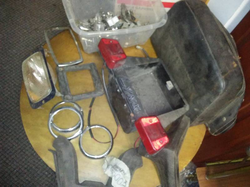lot 22 image: Light Bezels, lynx tail light assembly, back rest handle bar covers, handle bar clamps and more