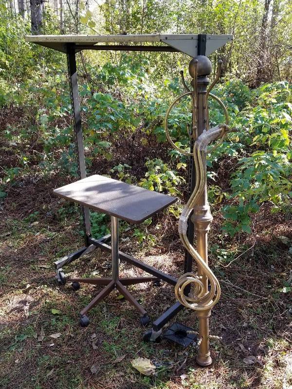 lot 153 image: Lot - Rolling Table, Brass Coat Rack, Rolling Coat Rack