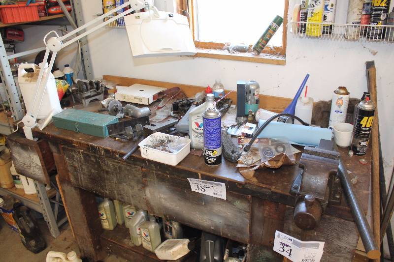 lot 38 image: Contents of Wood Table Includes Motorcycle Parts, Fluids, Misc Hardware and Tools