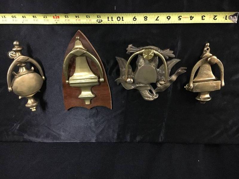 lot 28 image: Four Brass Door Knockers