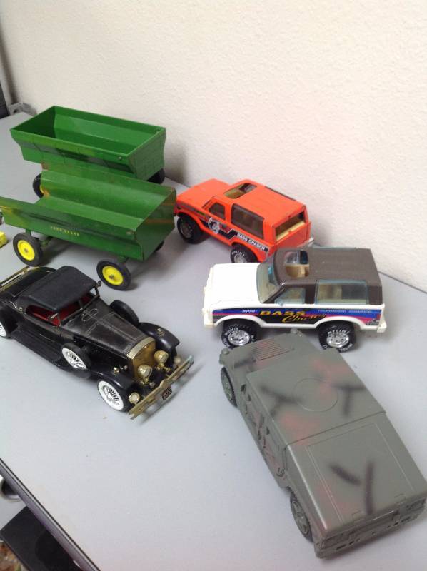 John Deere Trailer, 2 SUV Toys, Army Toy, Older Car toy, and a states and Capital toy