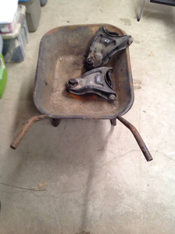lot 33 image: 57 Chevy Rocker Arms and Metal Wheel Barrow
