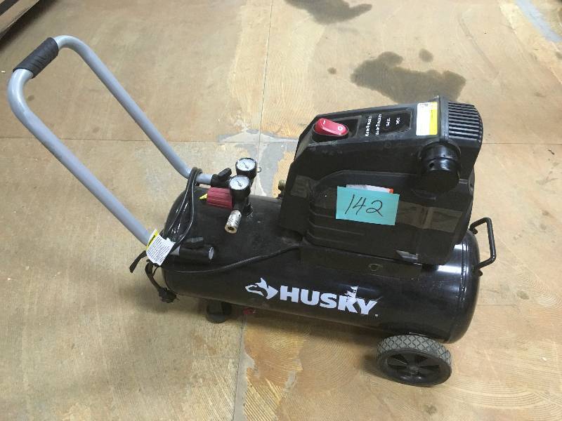 lot 142 image: Husky 8 Gal. Portable Oil Free Electric Air Compressor. in like New working conditions