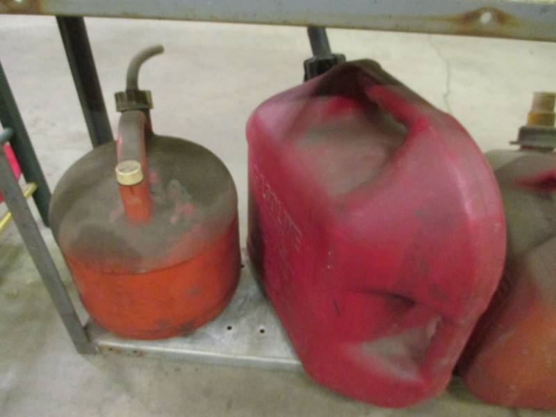 lot 207 image: Metal Rack, Gas Cans, Booster Packs & Bucket on Wheels