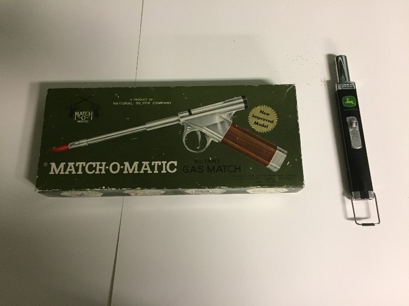 lot 5 image: Vintage Match O Matic Lighter & John Deere Zippo