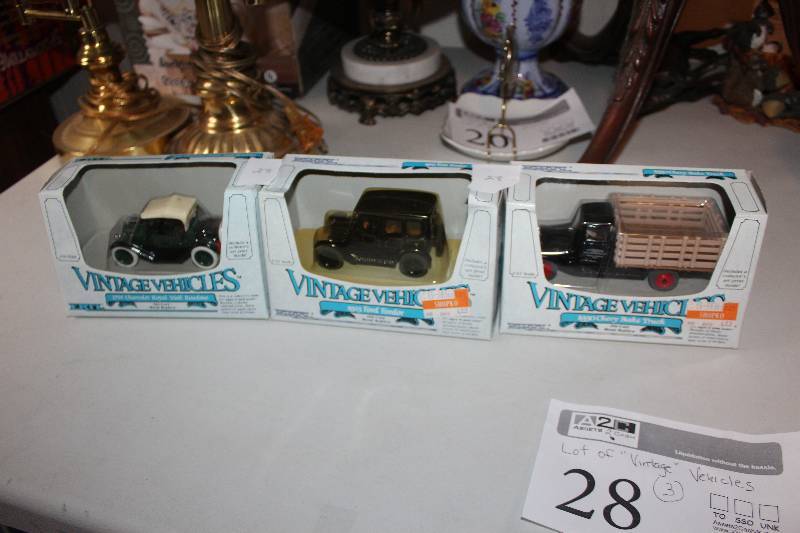 lot 28 image: Lot of (3) Vintage Vehicle Scale Die-cast Model Cars - 1914 Chevrolet Royal Mail Roadster, 1923 Ford Fordor, 1930 Chevy Stake Truck