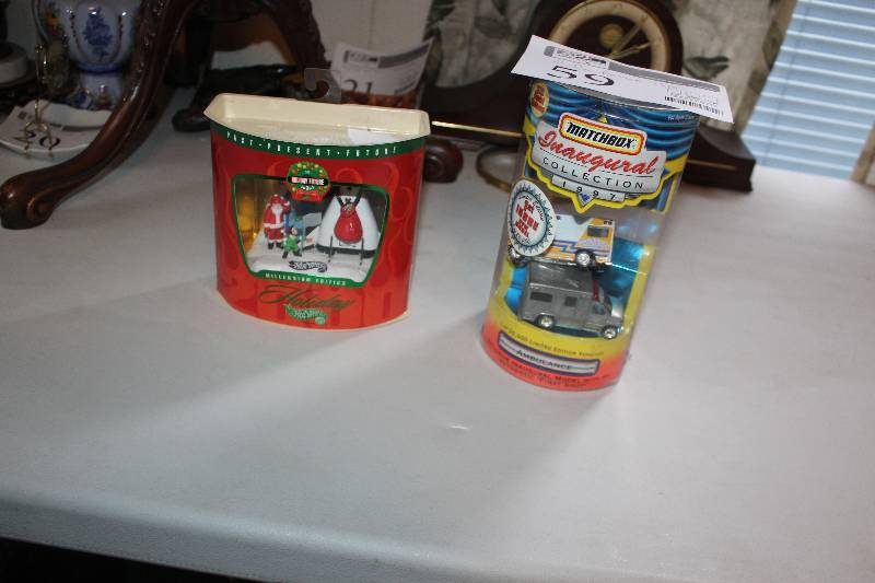 lot 59 image: Lot of (2) Car Action Toys - Hot Wheels Holiday Vehicles, Matchbox Inaugural Collection