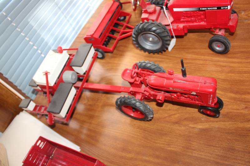 lot 596 image: International Harvestor McCormick Farmall Toy Tractor w Pull-Behind Farm Implement