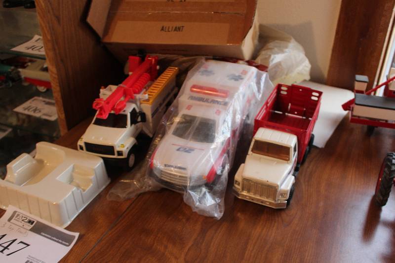 lot 447 image: Lot of (3) Toy Trucks - Stake Truck, Ambulance, Alliant Energy Repait Truck