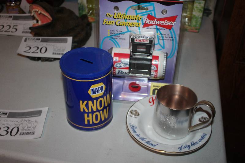 lot 1030 image: Budweiser Camera, NAPA Can of Know How Bank, Hamms Beer Ash Tray, Smirnoff Cup