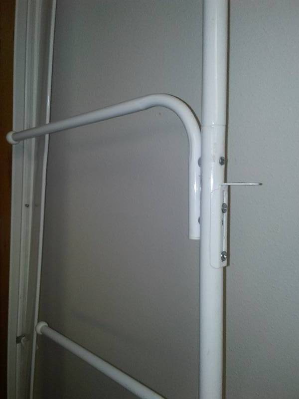 lot 60 image: Door Hanger organizer (attaches to door hinge) and Drapery Traverse Rods (2) 76 inches with hardware