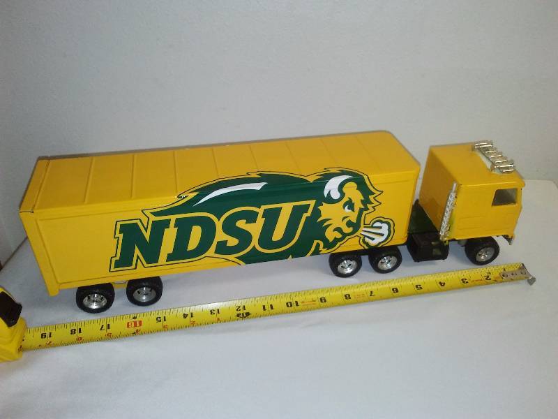 lot 111 image: NDSU Bison Football ERTL Display Truck Metal Semi Tractor Trailer, 19 inches long, Trademark Details