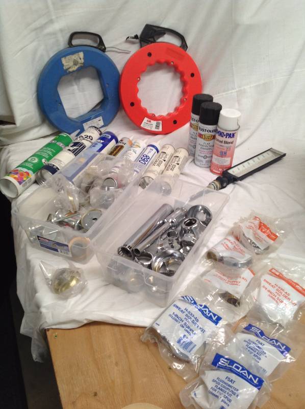 lot 15 image: Steel Tape, Spray Paint, Sweat Solder Kits, Door Stops (multiple kinds) Thermostat, Various Tubes of Caulk