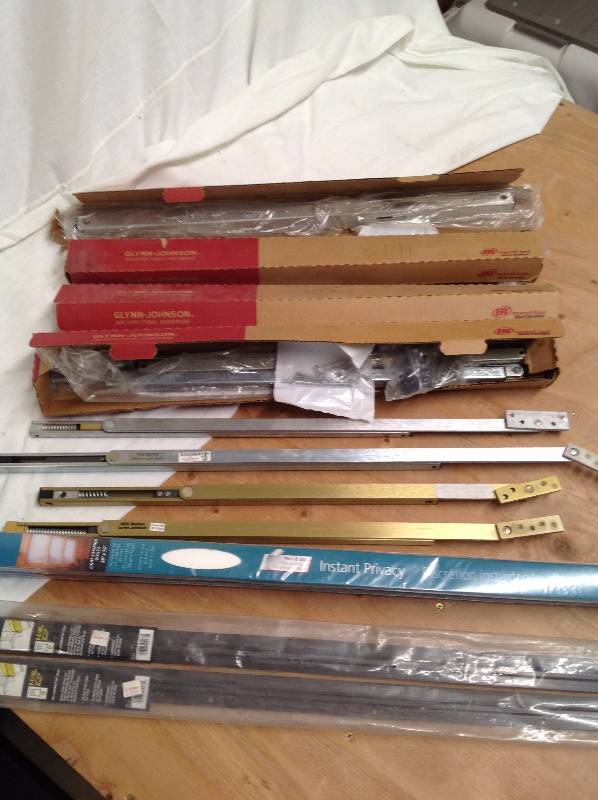lot 16 image: 8 -Heavy Duty Overhead Door Stop, 2 Pleated Shades, 36 by 72 and, 2 Door Sweeps 36 Inch