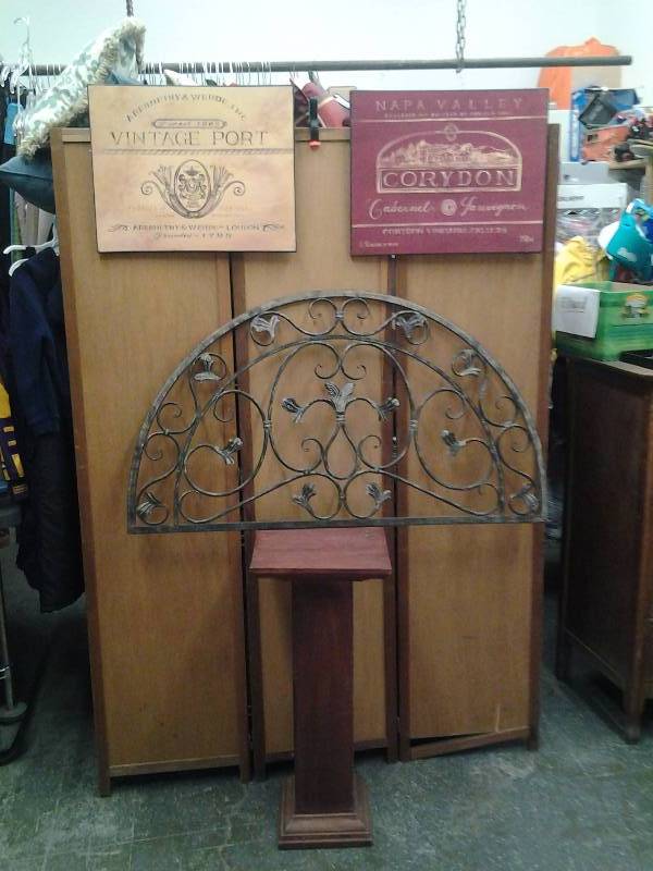 lot 7 image: Wood Pedestal Plant Stand, Ornamental Metal Wall Decor, 2-Canvas Wine Label Wall Art
