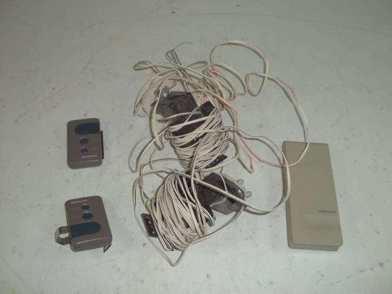 lot 71 image: Craftsman Garage door opener parts including remotes